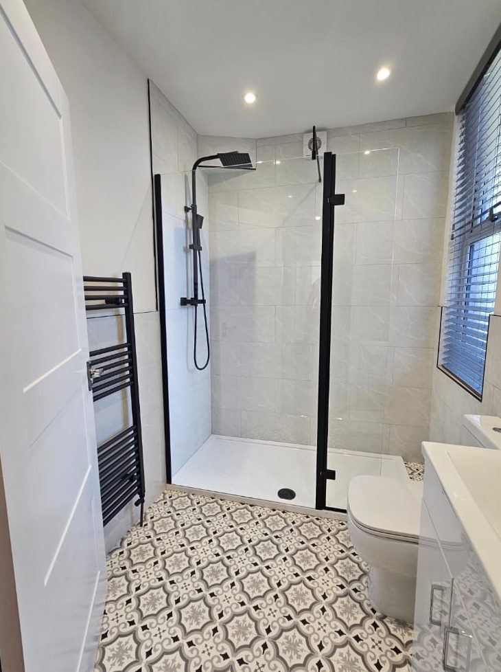 Post-construction clean of a new shower room with patterned floor tiles